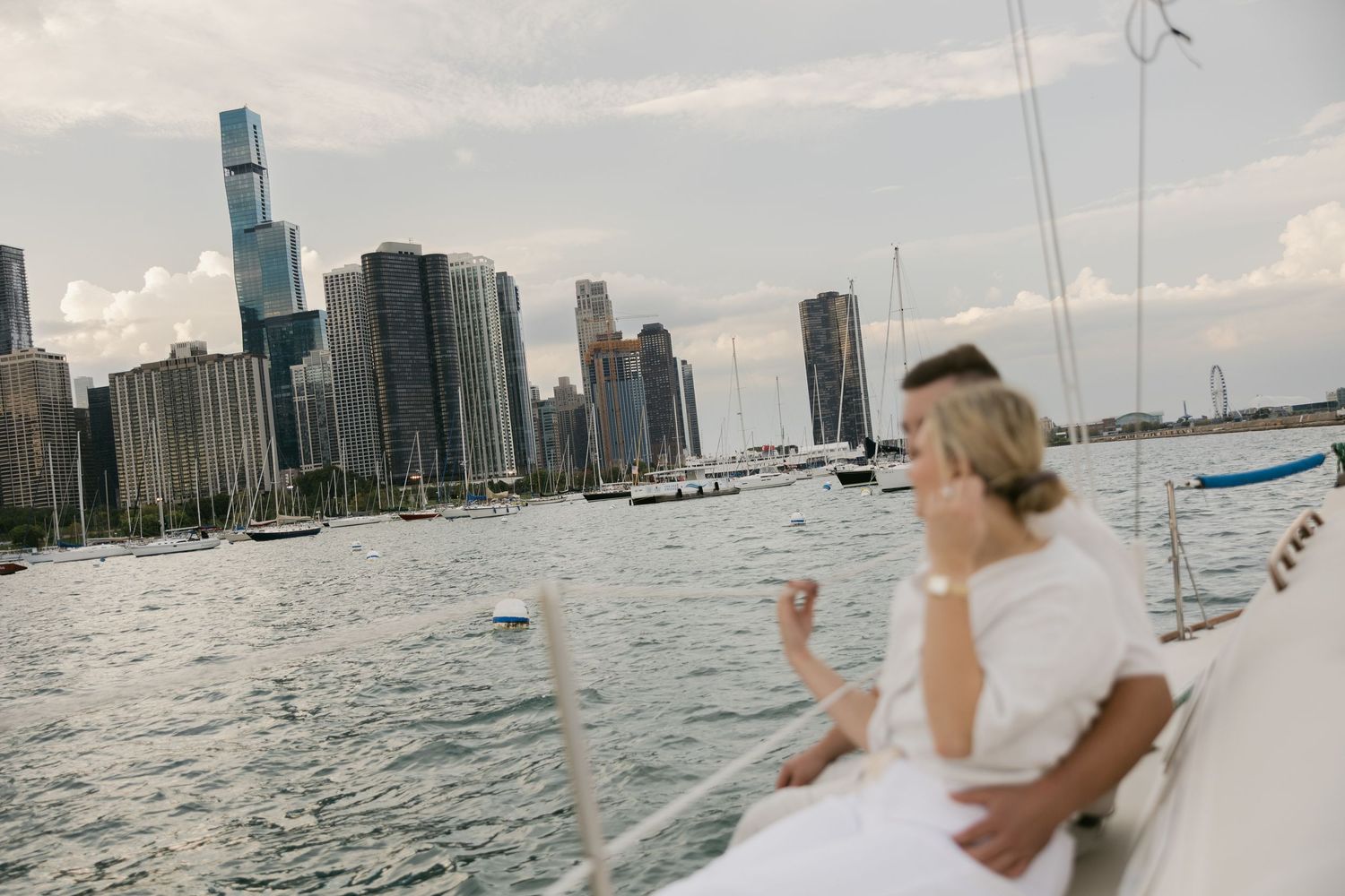 Panoramic view of a cityscape from a sailboat on calm waters.