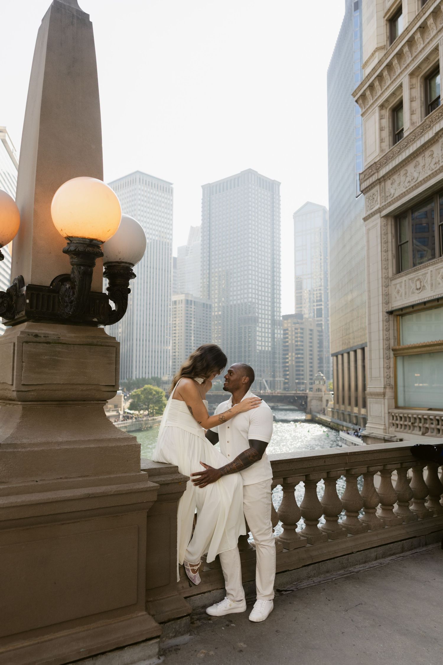 Urban rooftop photo session with Chicago skyline and vintage street lamps in background.