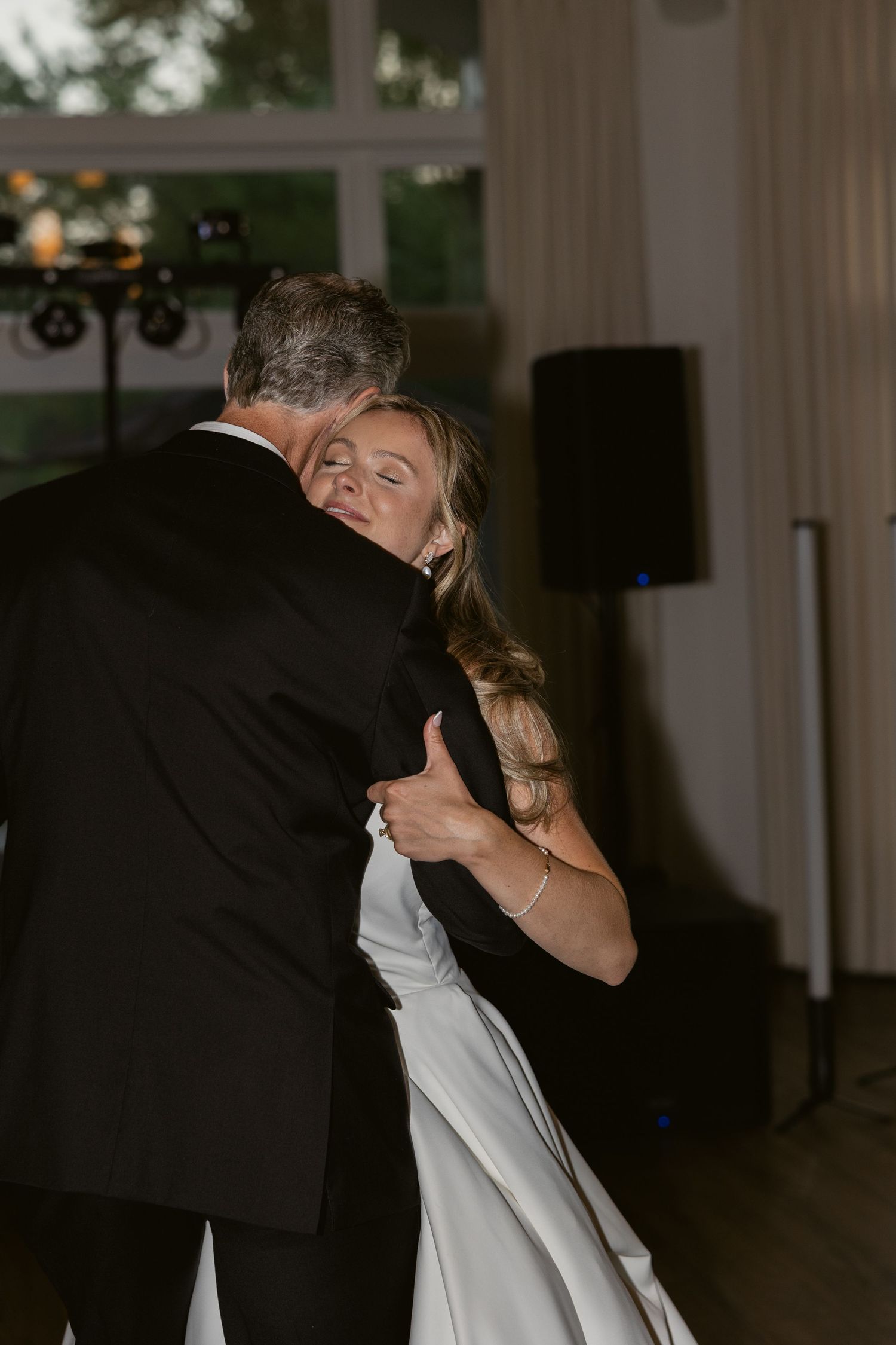 Intimate dance moment captured during wedding reception in elegant venue.