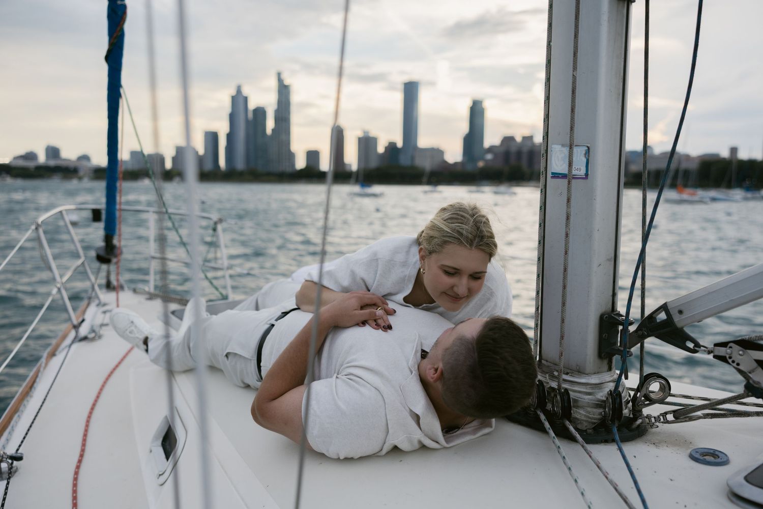 Romantic sailing adventure with city skyline creating a dramatic backdrop.
