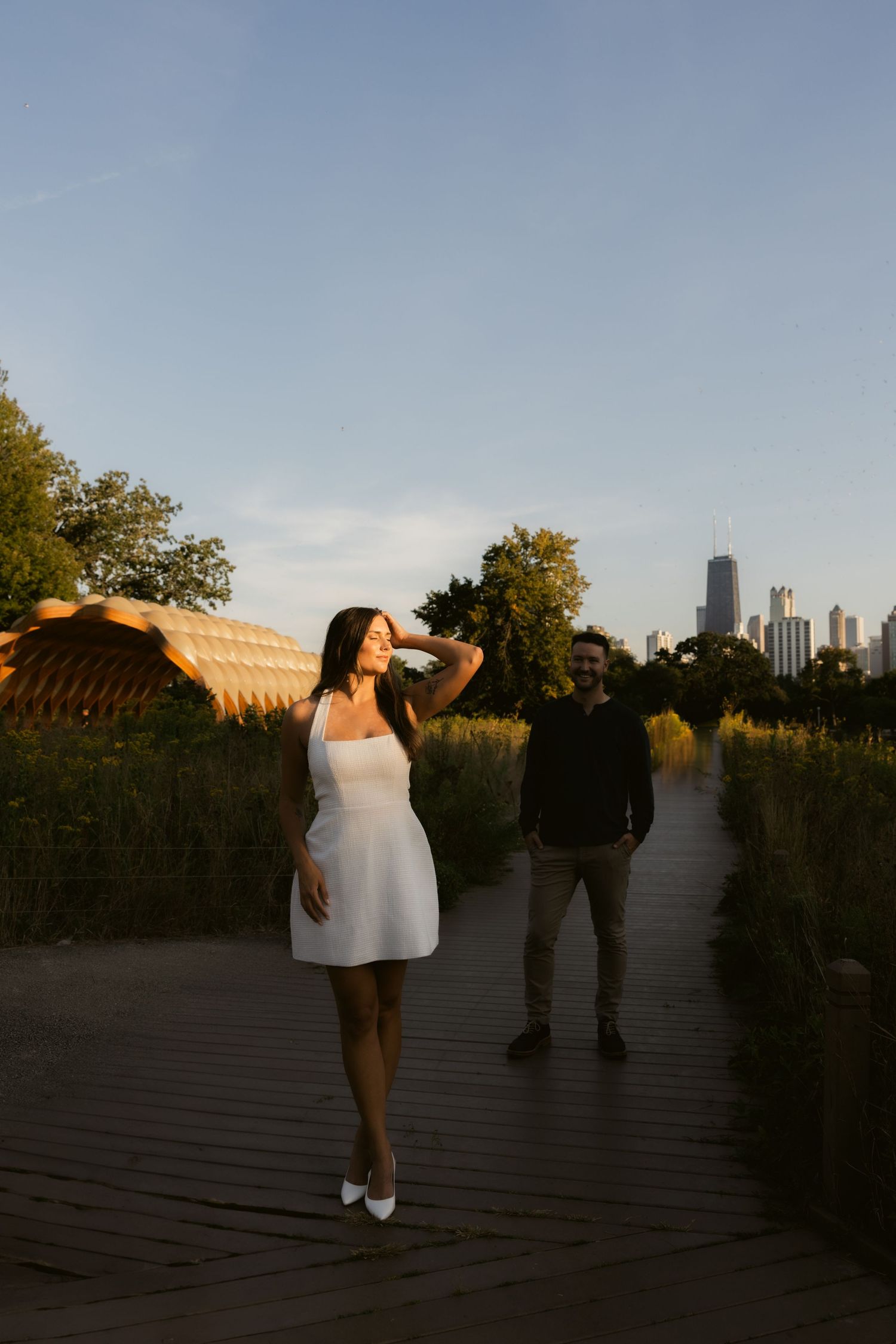 Artistic silhouettes against urban backdrop during golden hour photo session.