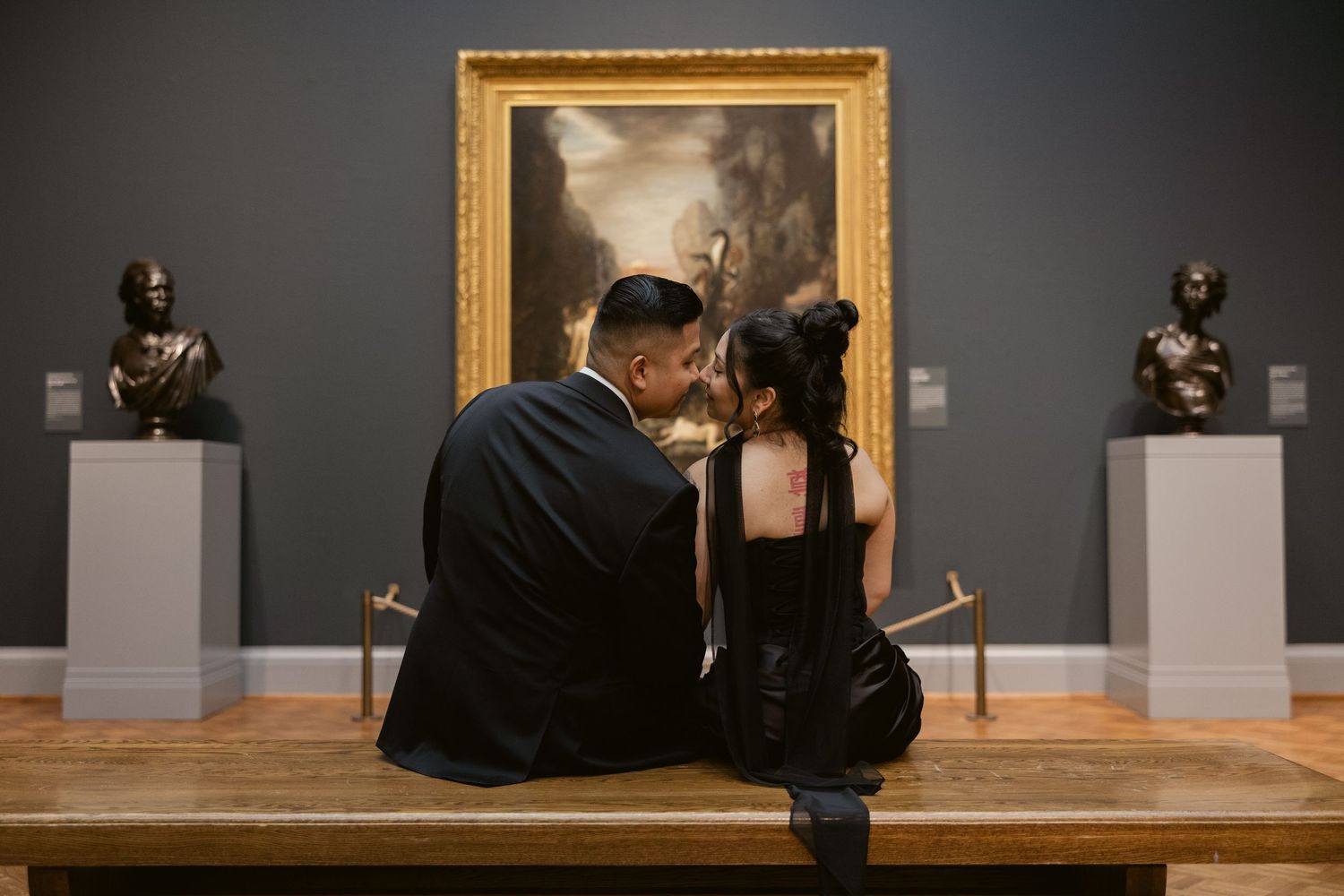 A romantic scene unfolds in an art museum gallery with classical paintings.