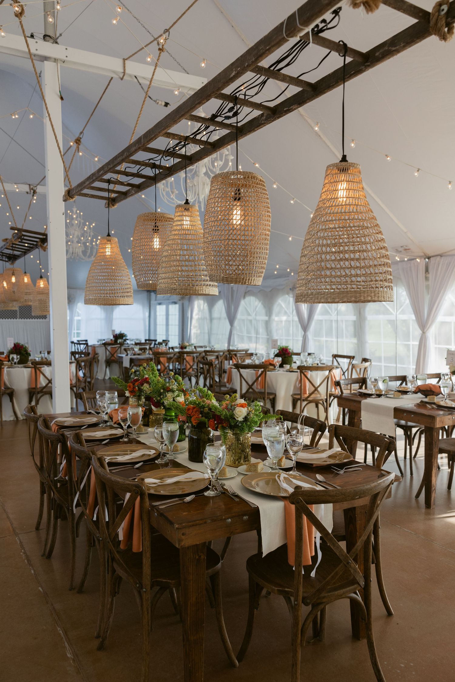Modern restaurant interior with woven basket pendant lights and wooden tables set for dining under string lights.