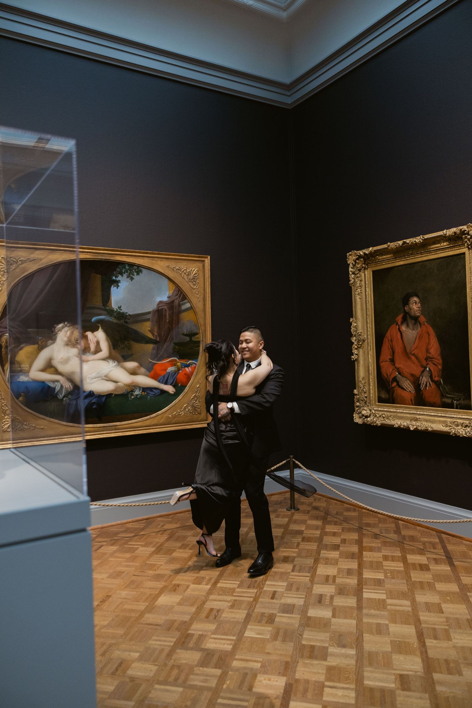 A photographer captures artistic shots in a museum gallery with classical paintings.
