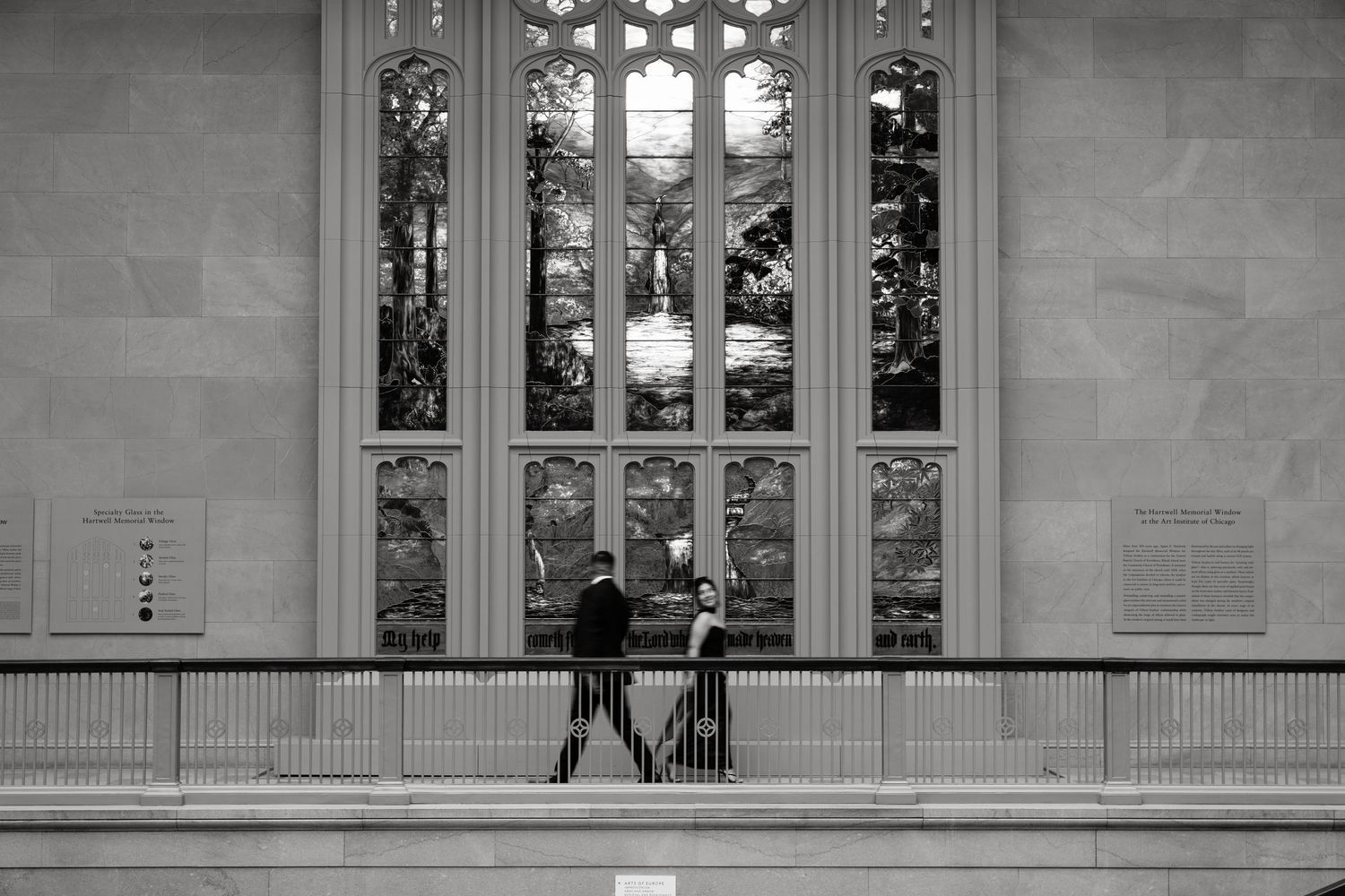 Gothic-style windows with ornate stonework in a classical building interior.