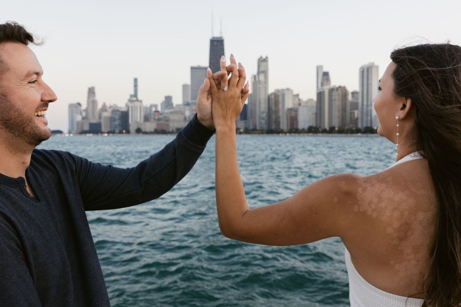 Dancing couple silhouetted against Chicago waterfront at dusk.
