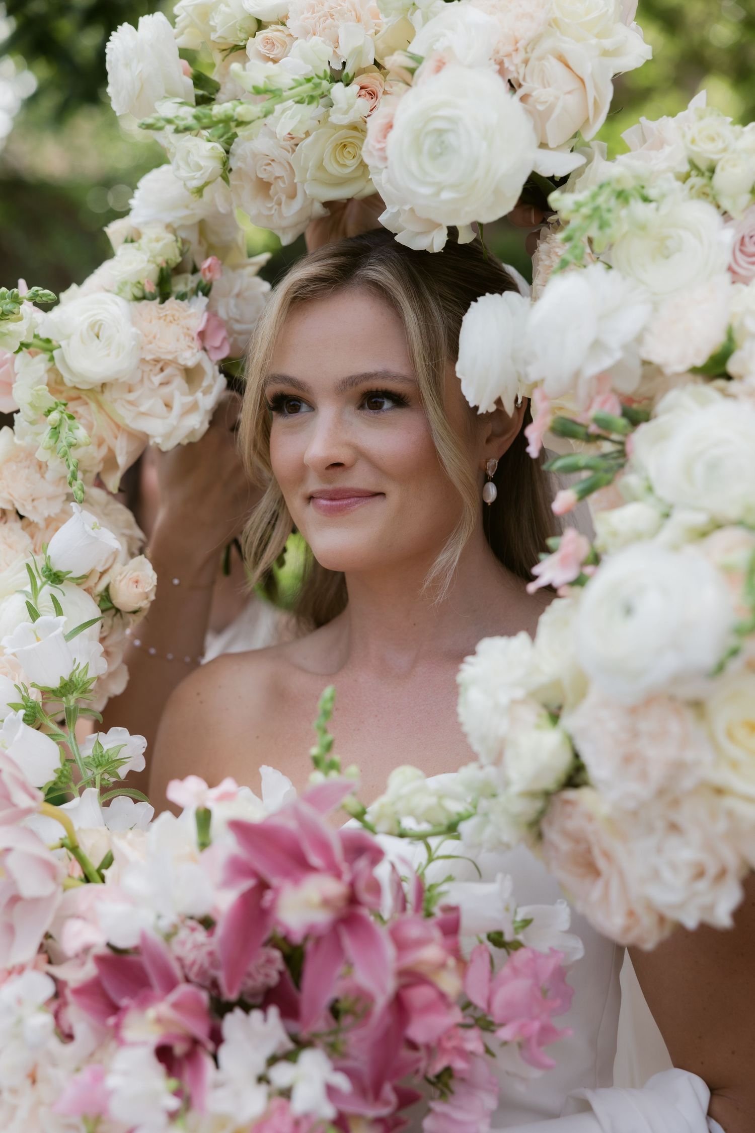 Beautiful floral arrangement with white roses and pink lilies framing the scene.