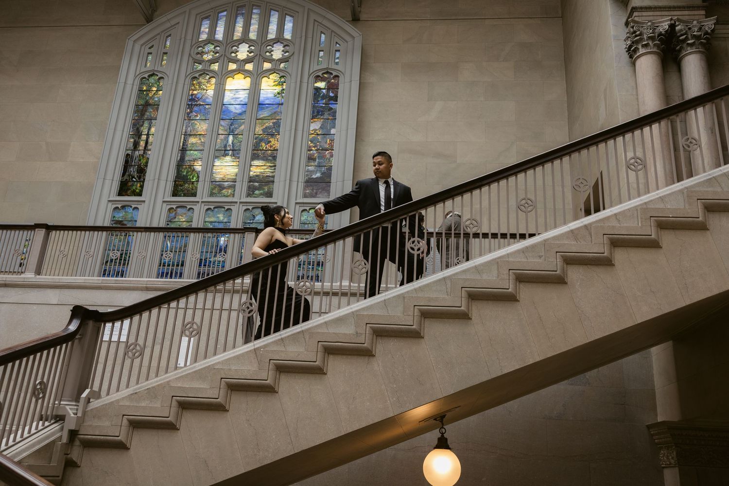 A sequence of photos showing someone walking up an elegant staircase with large windows and white railings in an interior space.