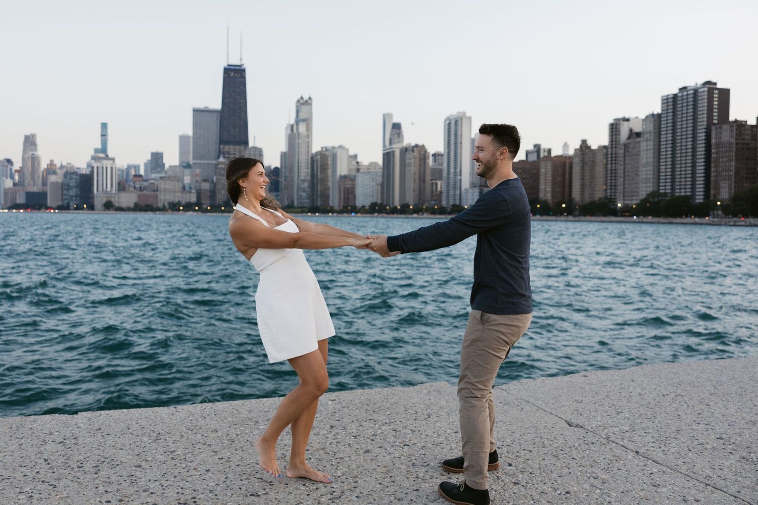 Couple enjoying sunset along Lake Michigan with Chicago's iconic skyline in background.