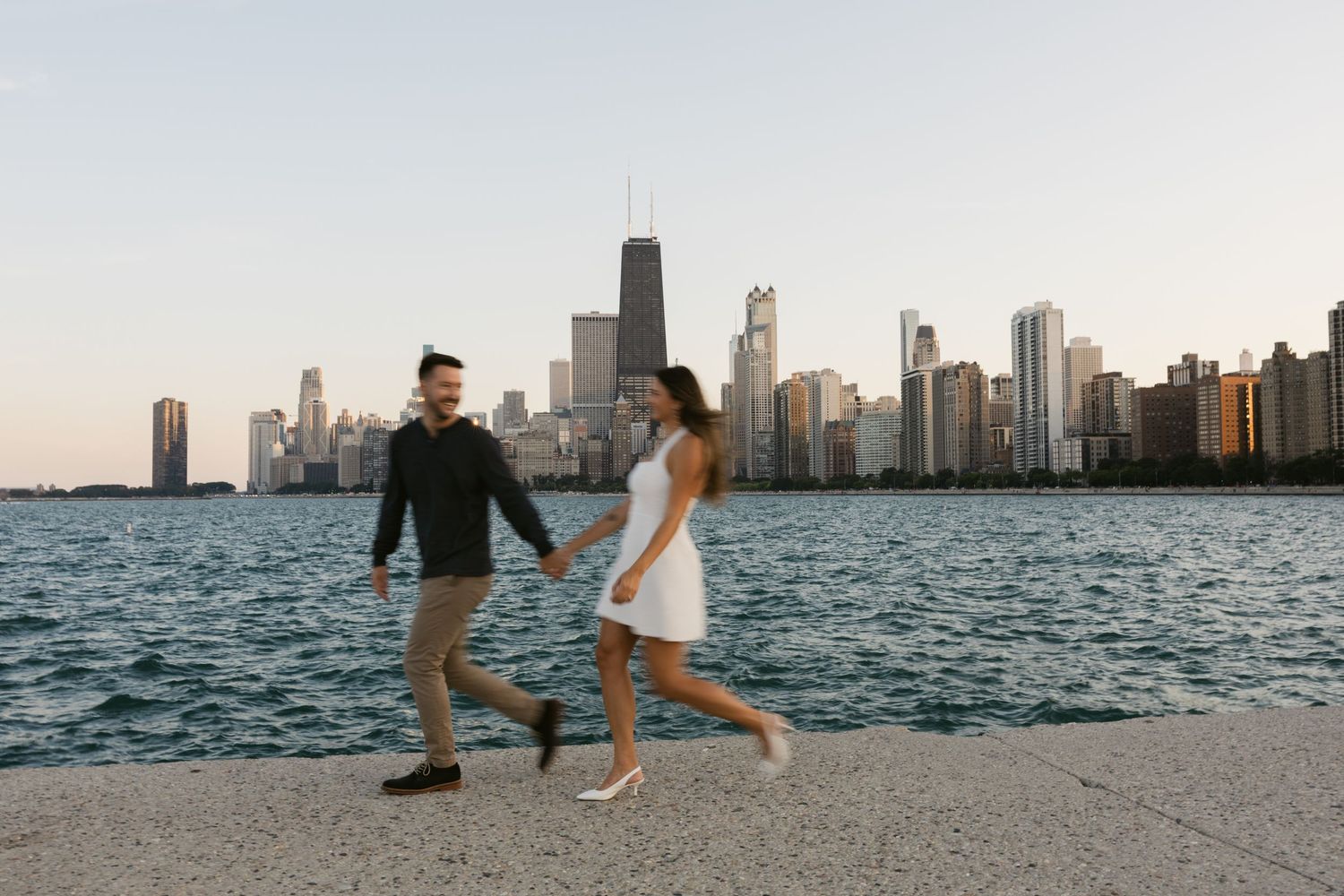 Chicago skyline frames a romantic moment along Lake Michigan's shoreline.