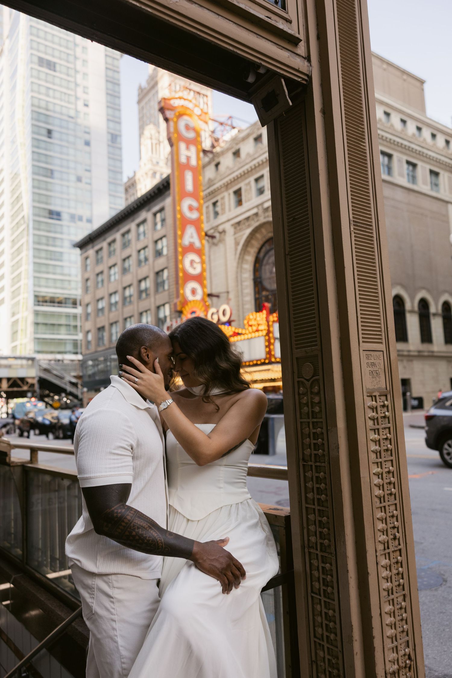 A romantic moment captured outside the historic Chicago Theatre with its iconic marquee.