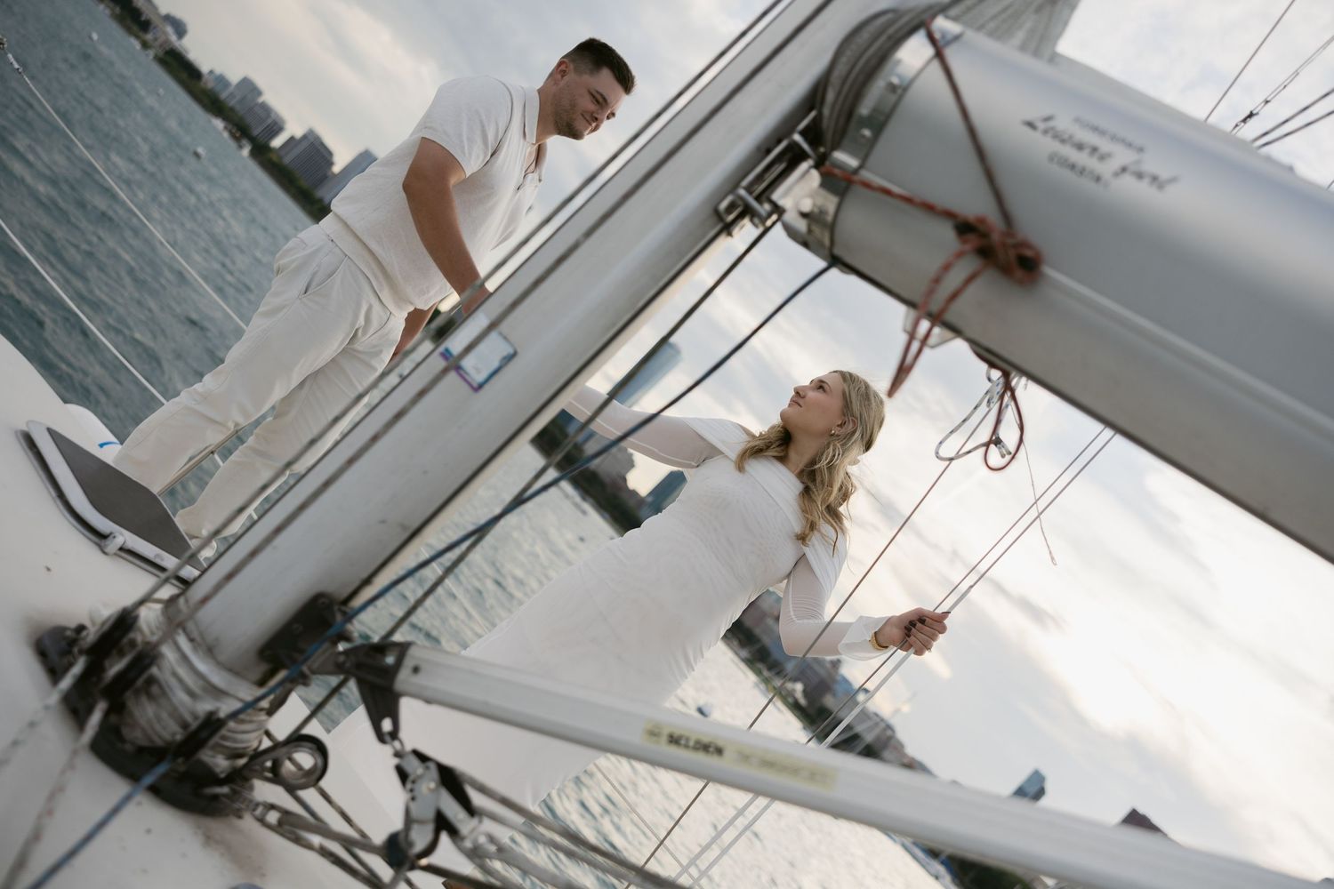 Intimate sailing moment captured against a cloudy maritime backdrop.