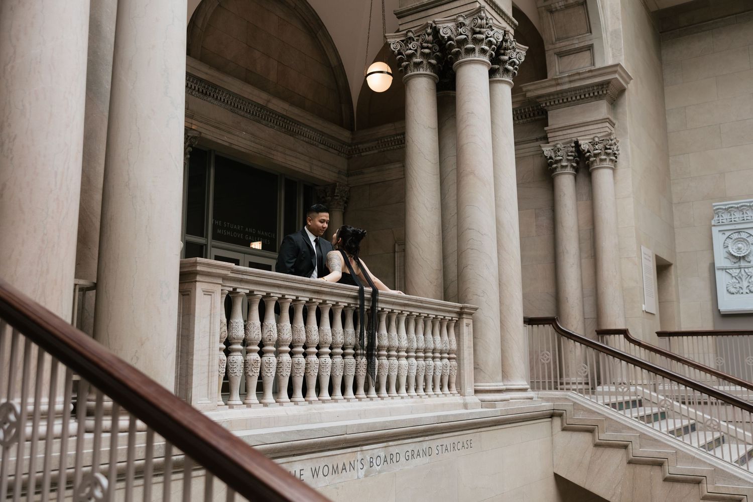 A classical architecture interior with stone columns and ornate balustrades.