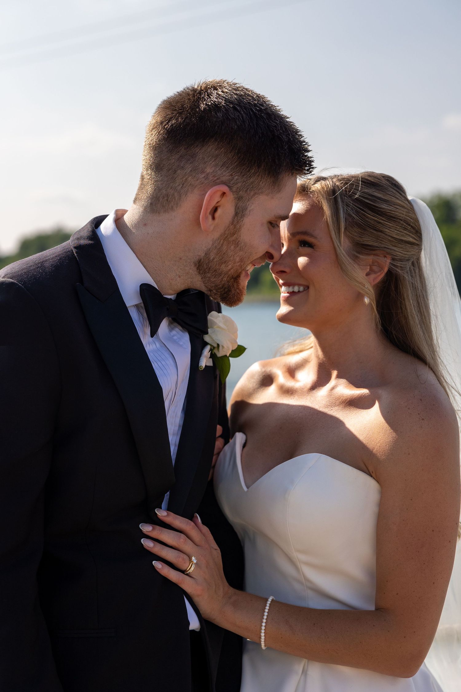 An intimate wedding portrait captured during sunset with soft natural lighting.
