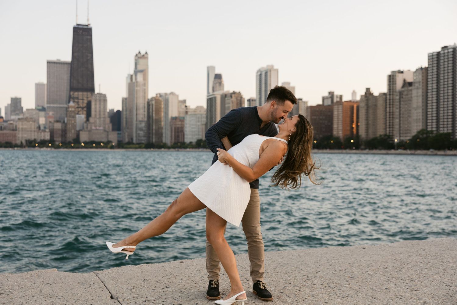 A romantic moment captured on the beach with Chicago's magnificent skyline in the background.
