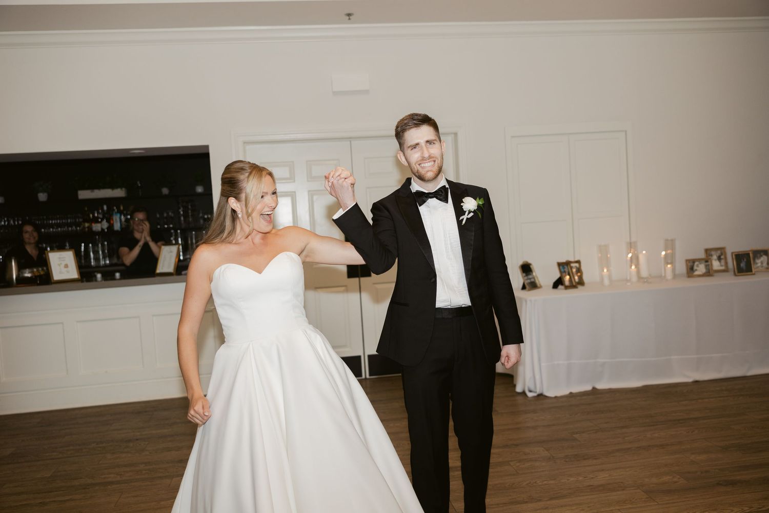 Wedding couple dances together in an elegant indoor reception venue.