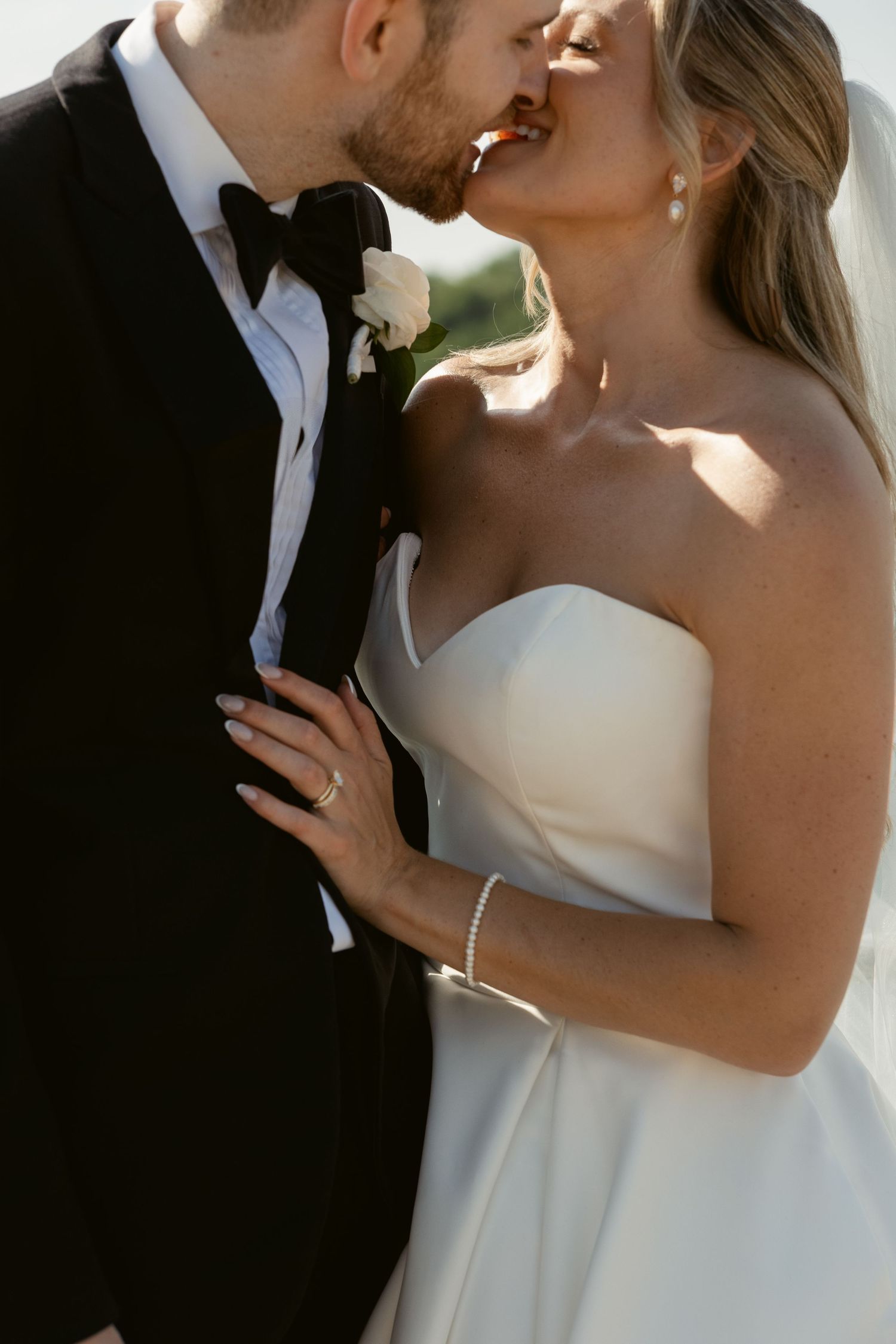 Close-up romantic moments between newlyweds in formal wedding attire.