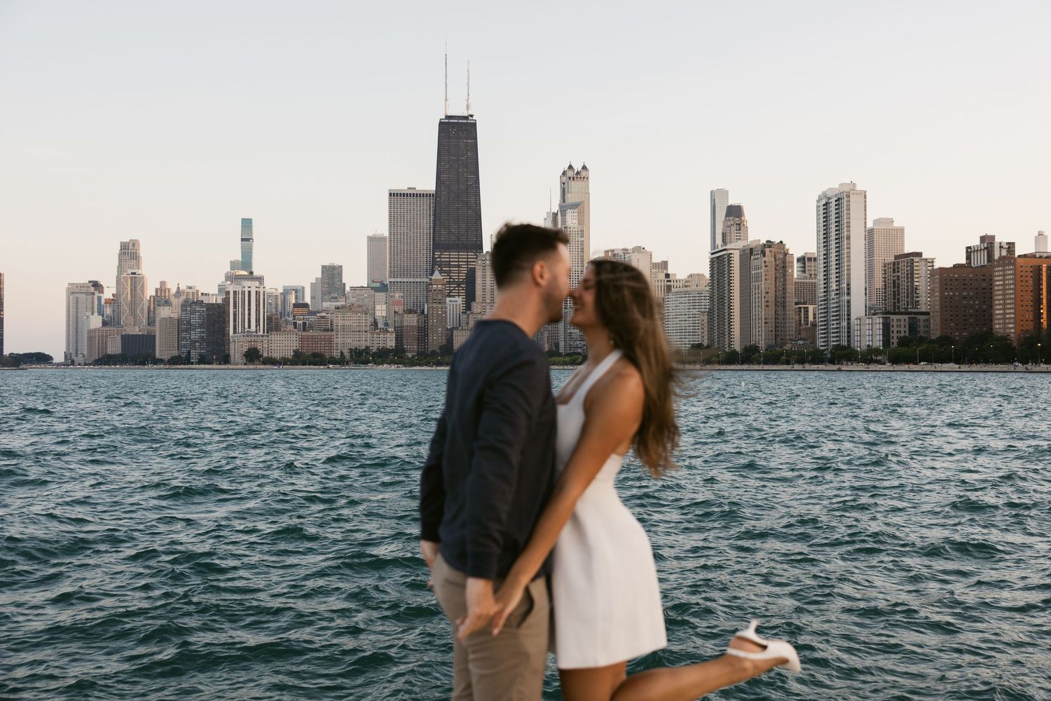Romantic sunset photoshoot with Chicago's dramatic skyline reflecting on Lake Michigan.