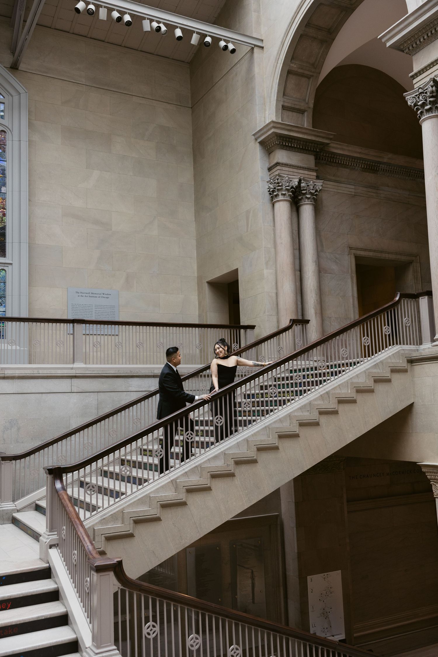 A series of four architectural photos showing a grand marble staircase in an elegant interior space.
