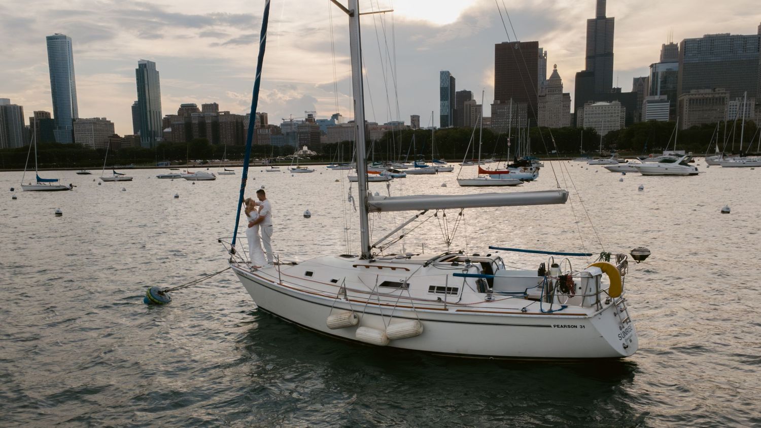 Panoramic view of sailboats anchored in Lake Michigan with Chicago's skyline in the distance.