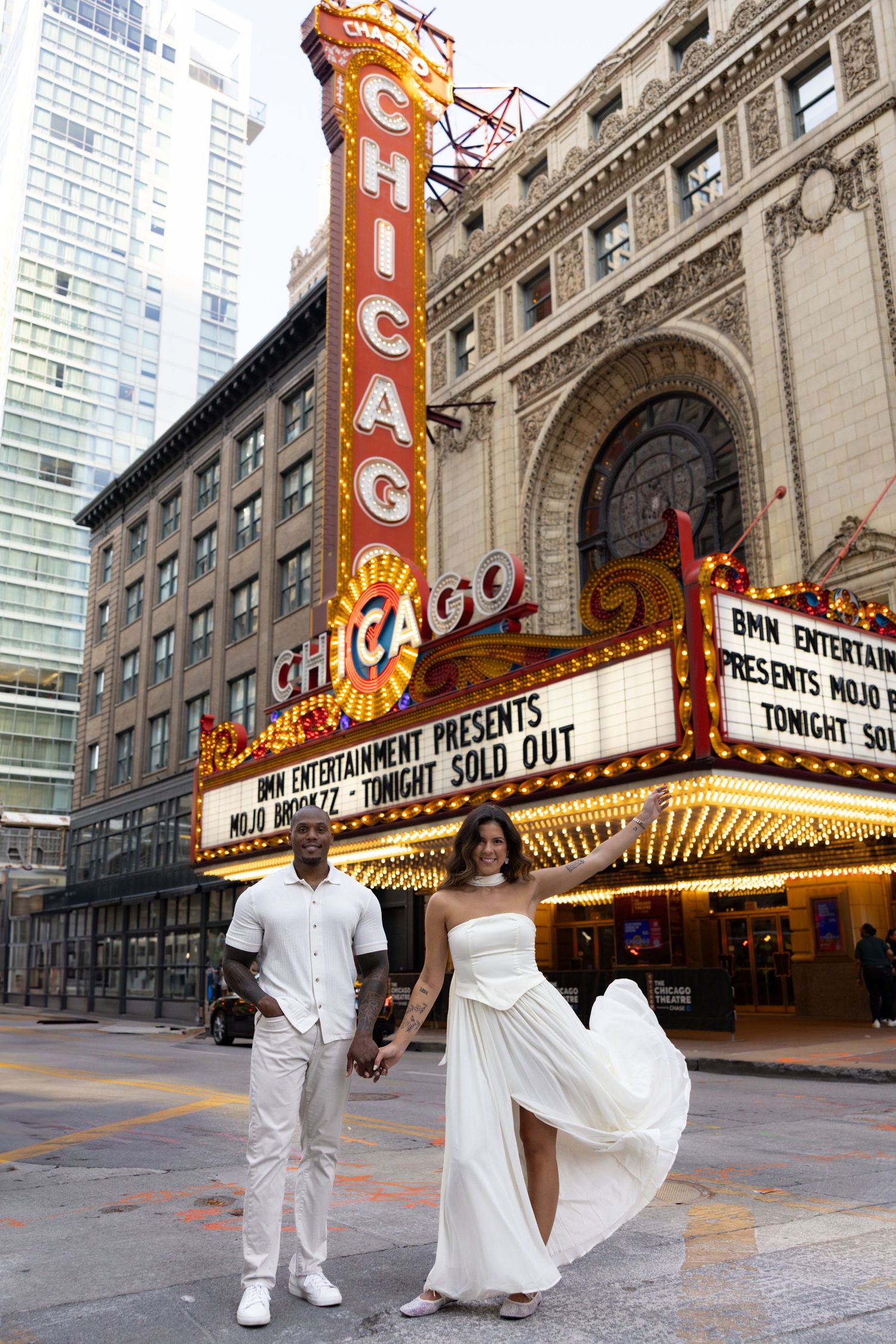 Romantic photo sequence outside historic Chicago Theater with illuminated signage.