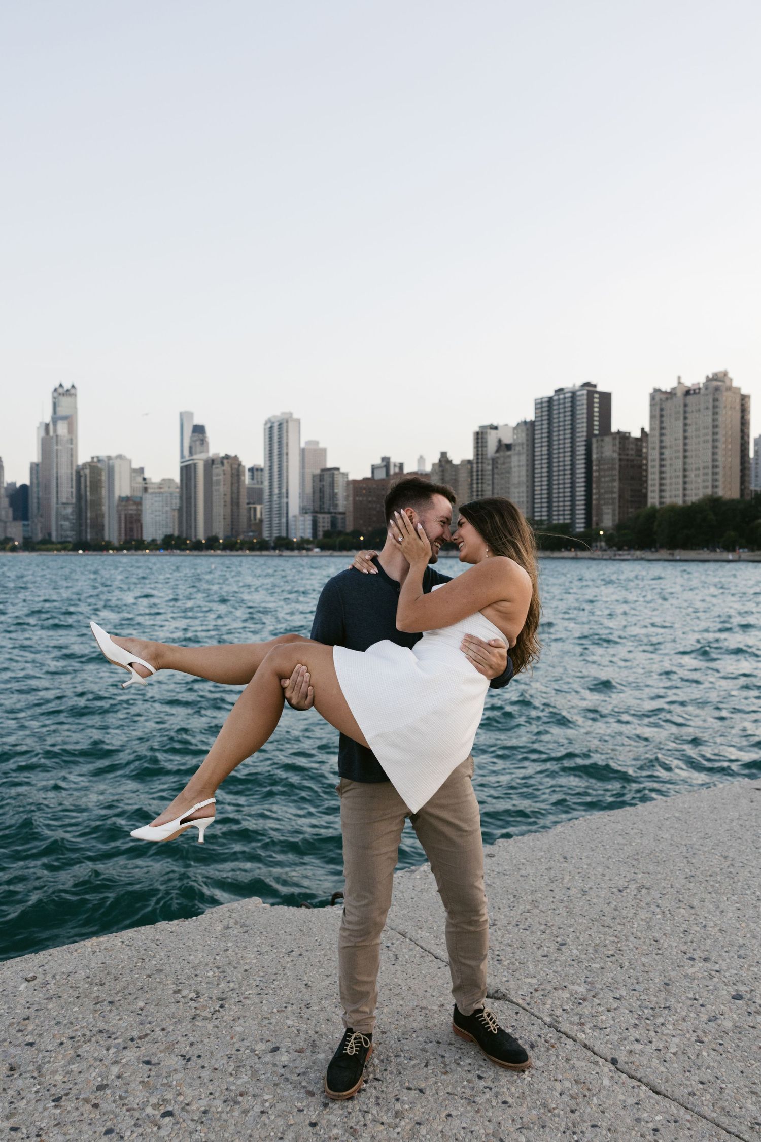 Romantic dip pose on the lakefront with Chicago's dramatic skyline and blue waters in view.