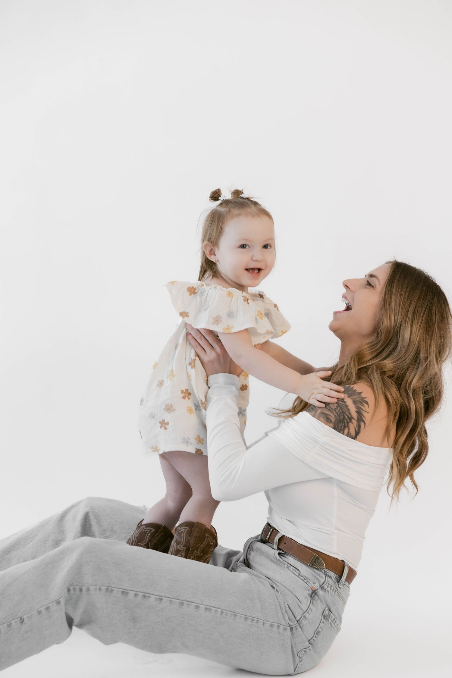 A heartwarming moment captured between two people during a white studio photography session.
