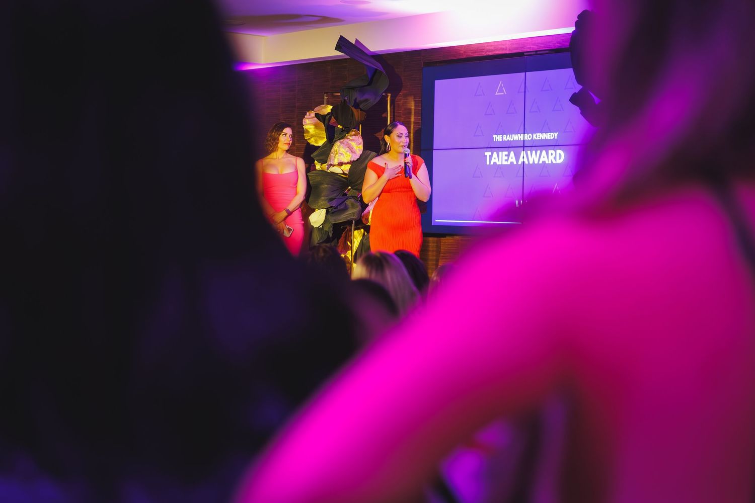 Presenter on stage at Lash Industry Awards during Tara Award announcement ceremony.