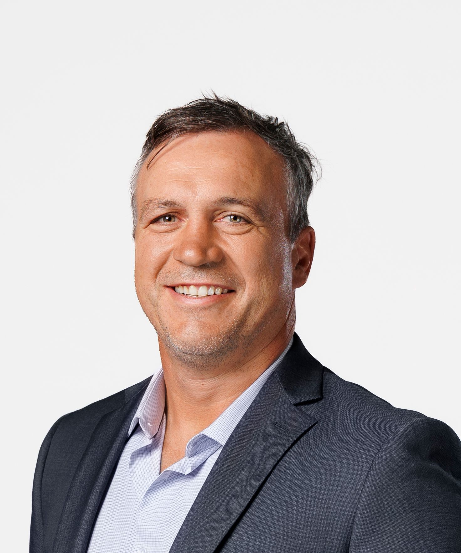 Professional headshot of a smiling middle-aged man with gray hair wearing a dark blazer and light shirt.