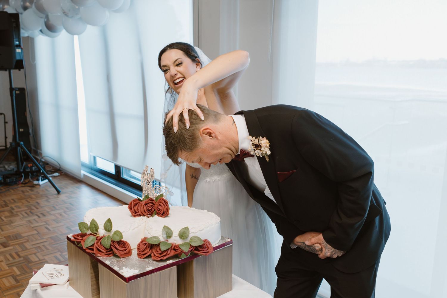 A candid moment between a bride and groom at an event table with appetizers during their wedding celebration.
