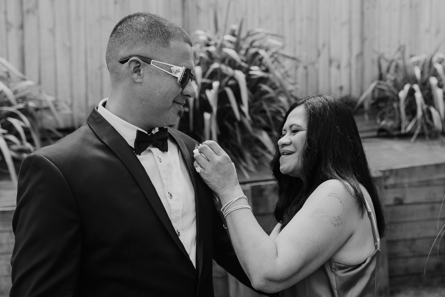 A black and white wedding photo collage showing intimate moments between newlyweds during their celebration.