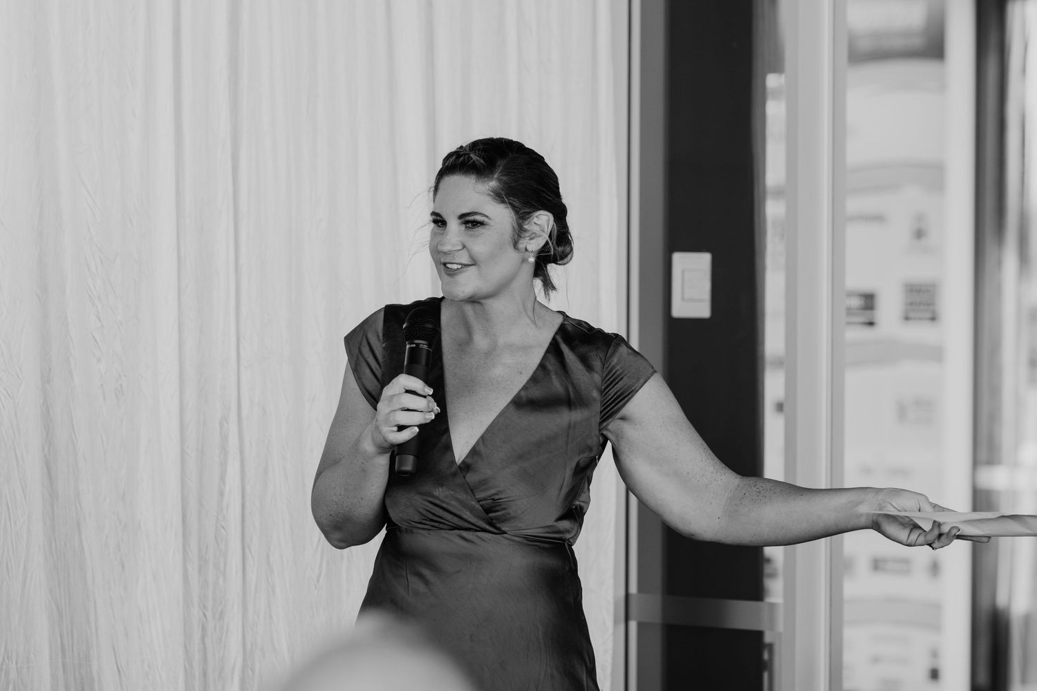 Wedding guests sharing laughs and stories during reception speeches. Papamoa Surf Lifesaving Club Wedding