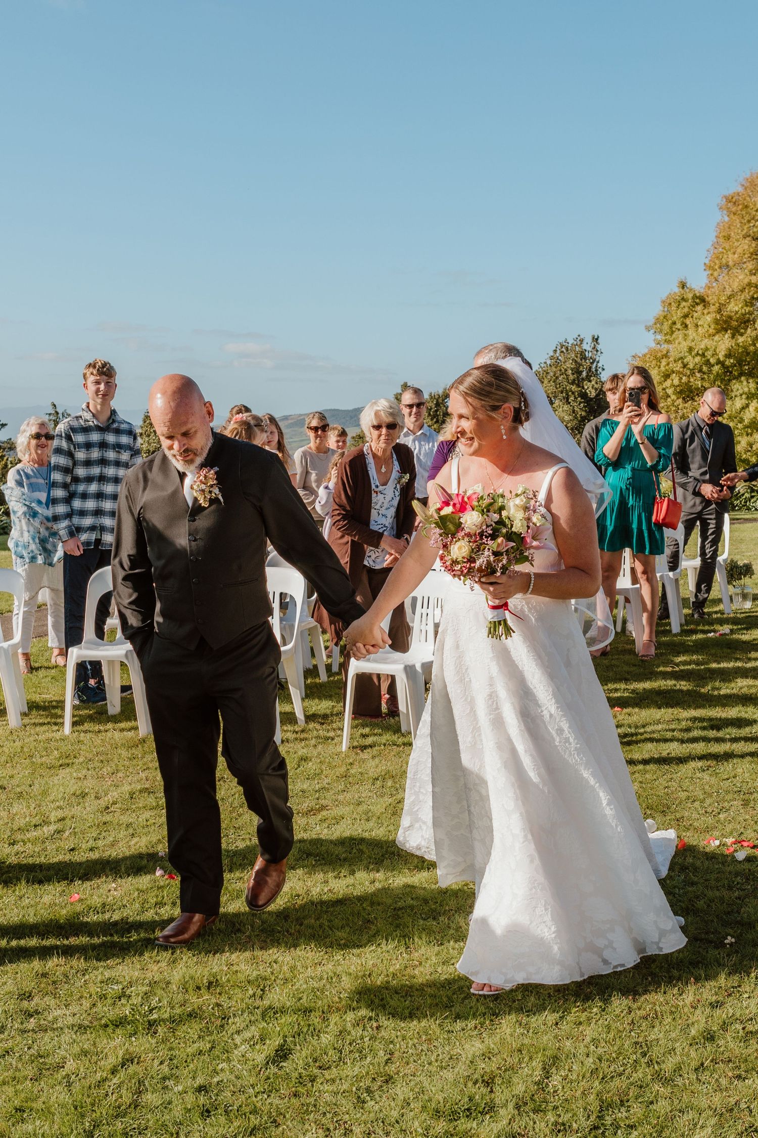 Sequence of wedding celebration photos showing joyful moments on a sunny grassy lawn with guests gathered outdoors.