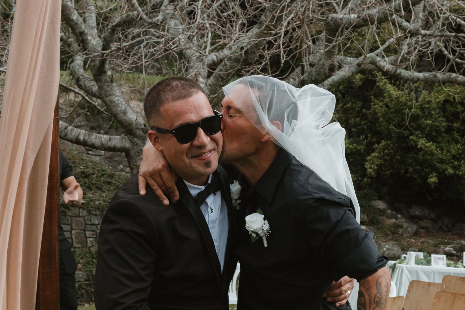 Bride and groom share intimate moments in a series of four black and white wedding photos.