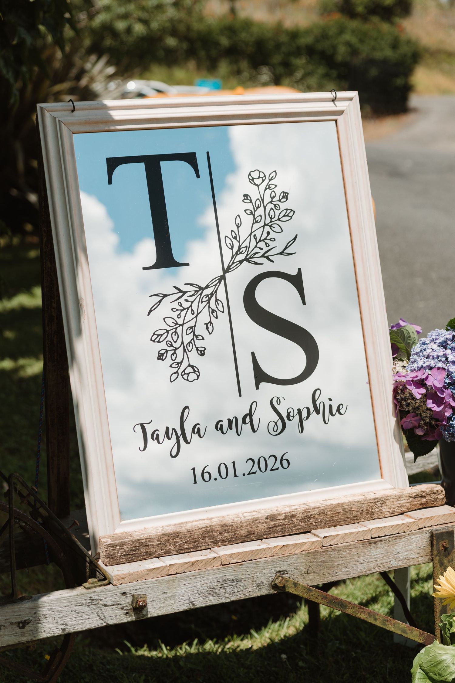 Elegant wedding welcome sign with initials T and S for Tayla and Sophie, dated 16.01.2026, displayed on a rustic easel.