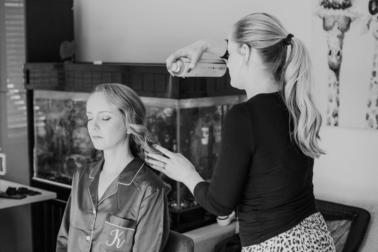 Candid black and white photographs showing pre-wedding preparations and interactions.
