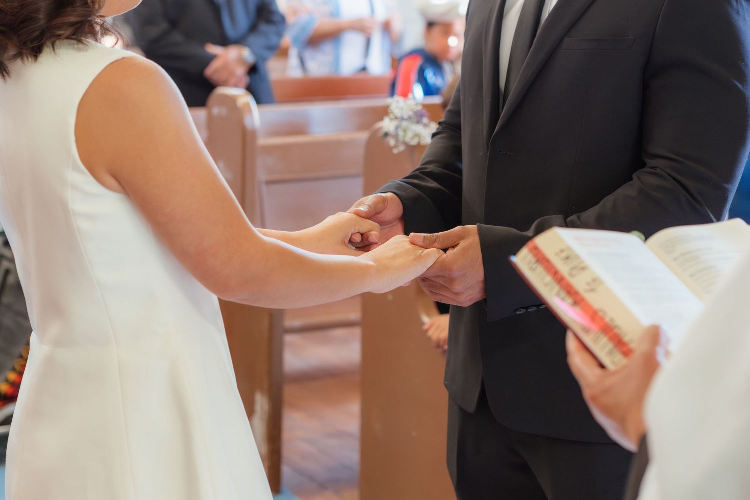 Wedding ceremony guests watch as the couple shares their first moments as newlyweds.
