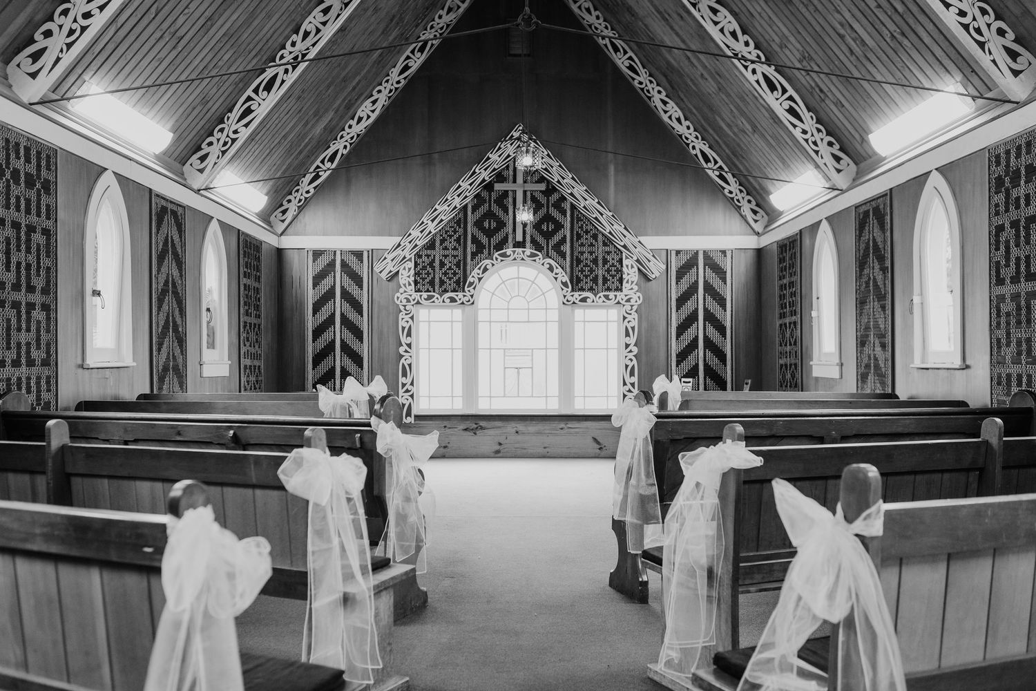 Four black and white photos show montage of wedding preparations in ornate church interior with traditional decorations.