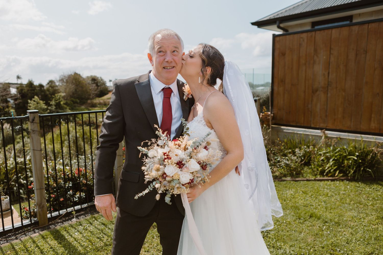 Sweet moment captured between bride and guest during outdoor garden wedding.