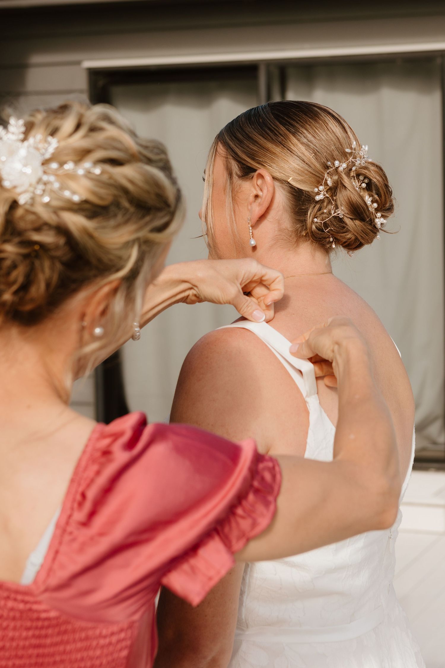 Wedding preparation scene showing delicate hairpins and accessories being arranged in an elegant updo hairstyle.