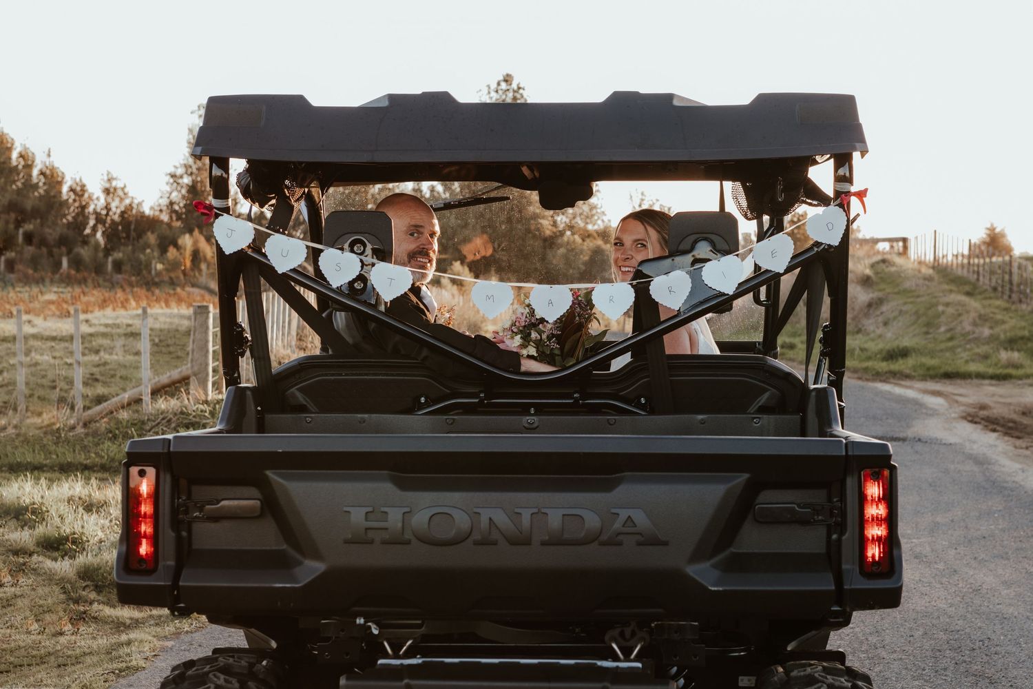 Black Honda car viewed from different angles showing front, side, and rear exterior details parked on a dirt road at sunset.