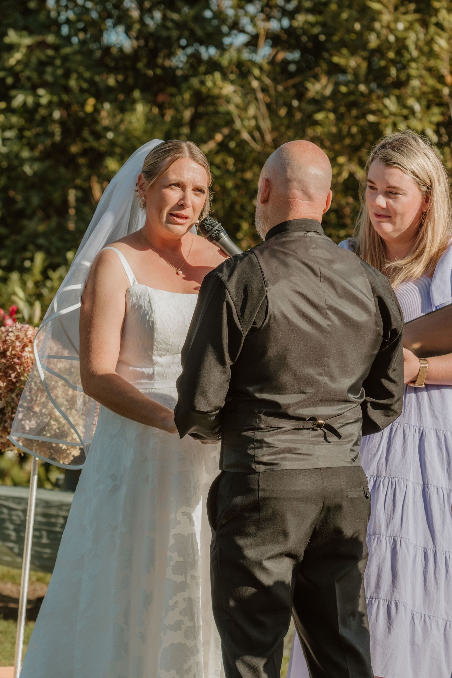 A series of candid wedding moments showing a couple and guests laughing together during an outdoor ceremony.