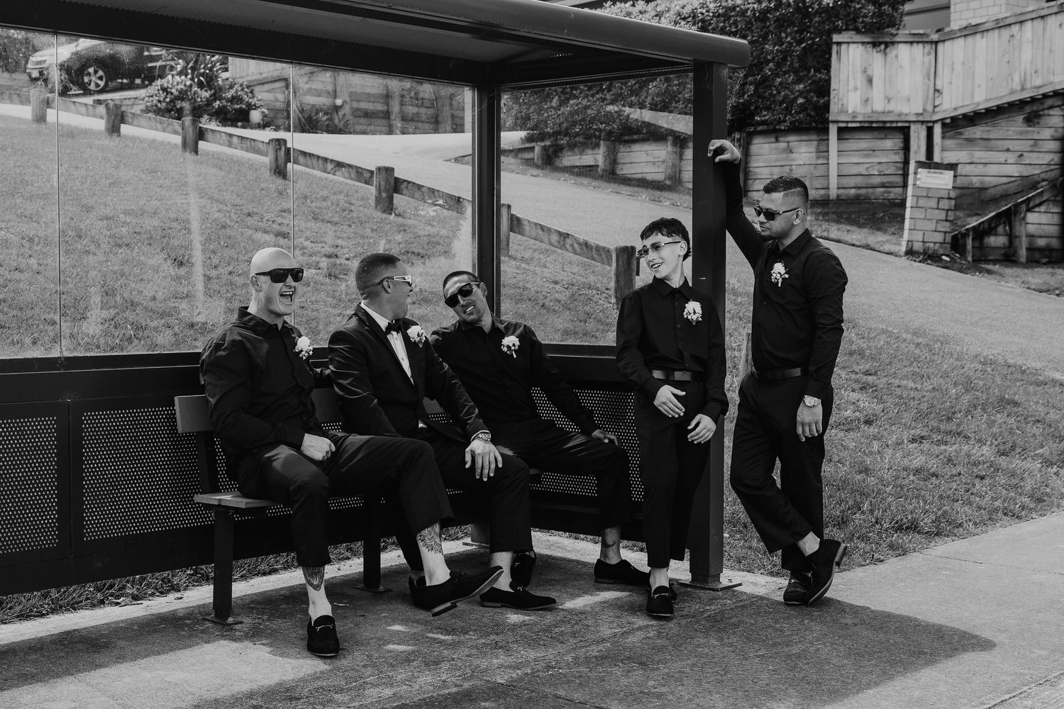 A black and white panoramic photo shows people sitting and resting on a hillside in an urban setting.