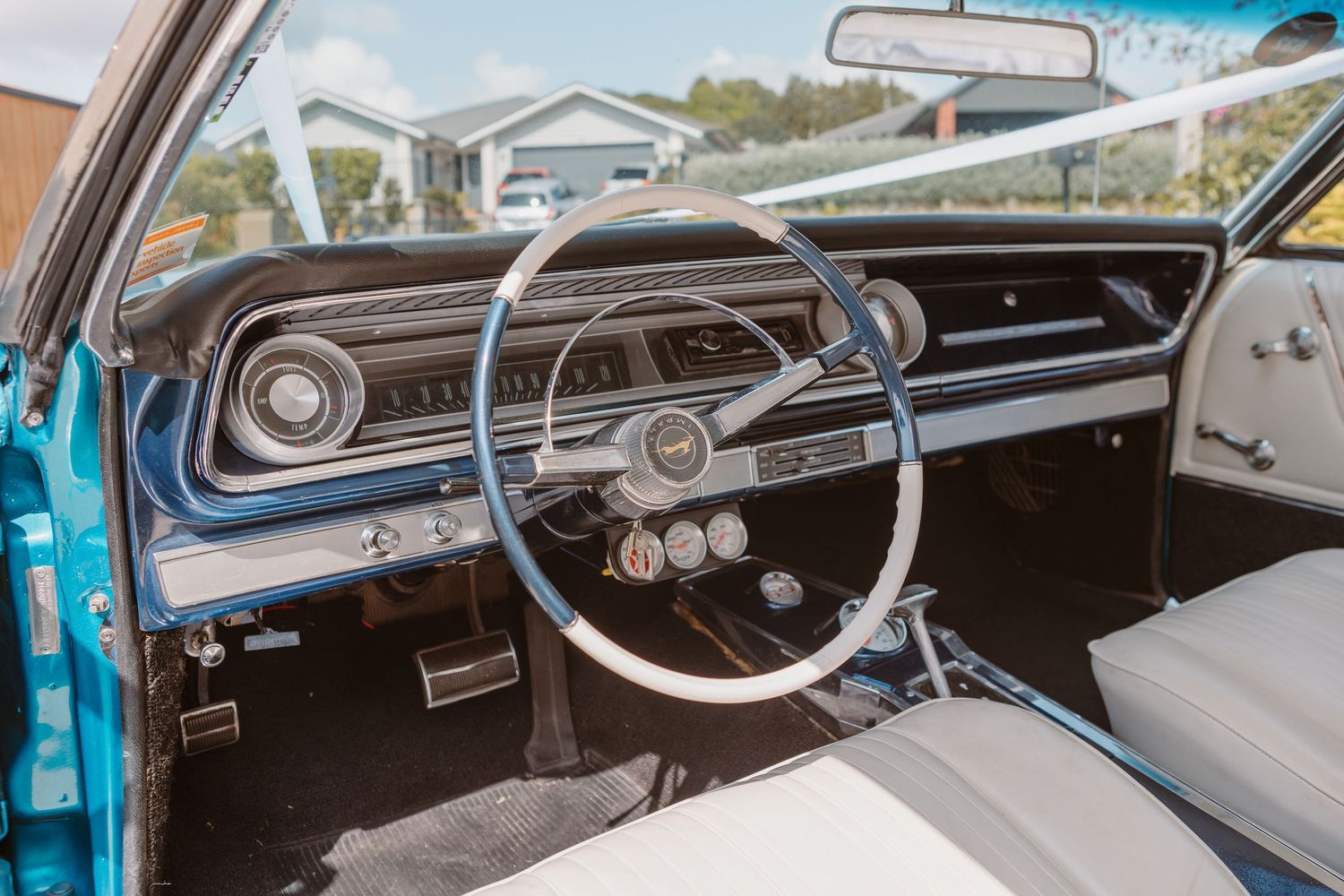 Collection of vintage car interior dashboard views showing classic steering wheels, gauges and control panels.