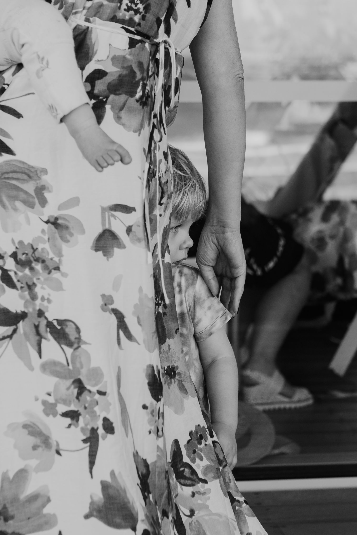 Black and white detail shot of a floral dress against window reflections. Papamoa Surf Lifesaving Club Wedding