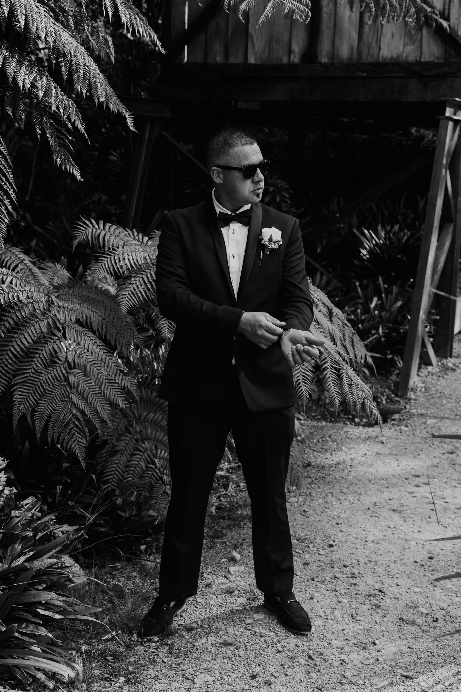Black and white photo series showing formal attire and ferns in an outdoor garden setting.