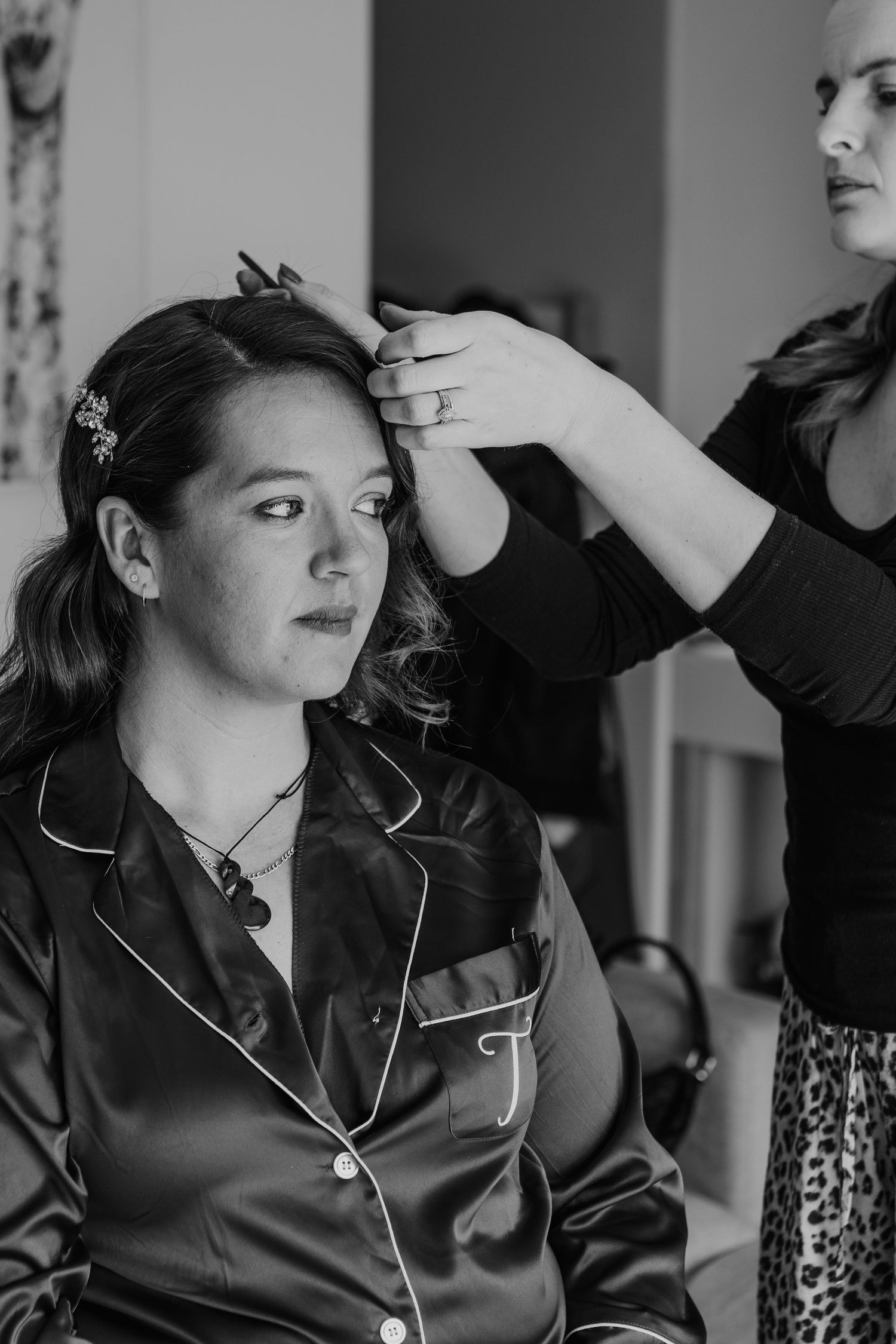 Getting ready sequence showing someone in black pajamas having their hair styled.