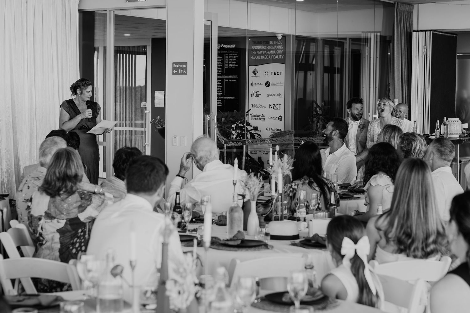 Multiple black and white photographs showing people gathered in dining halls and meeting spaces throughout various events.