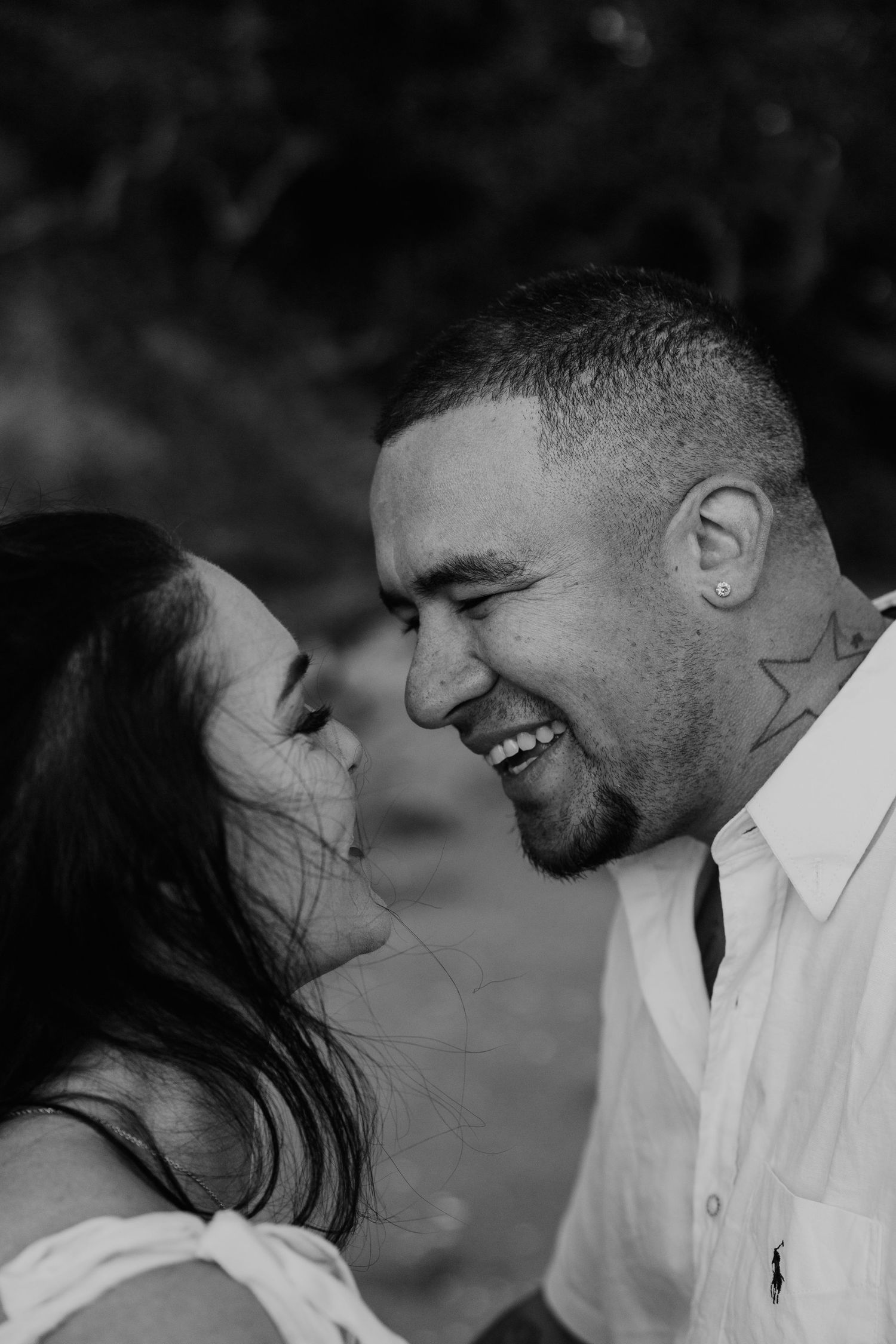 A romantic black and white photo series showing a couple sharing intimate moments and laughter together.