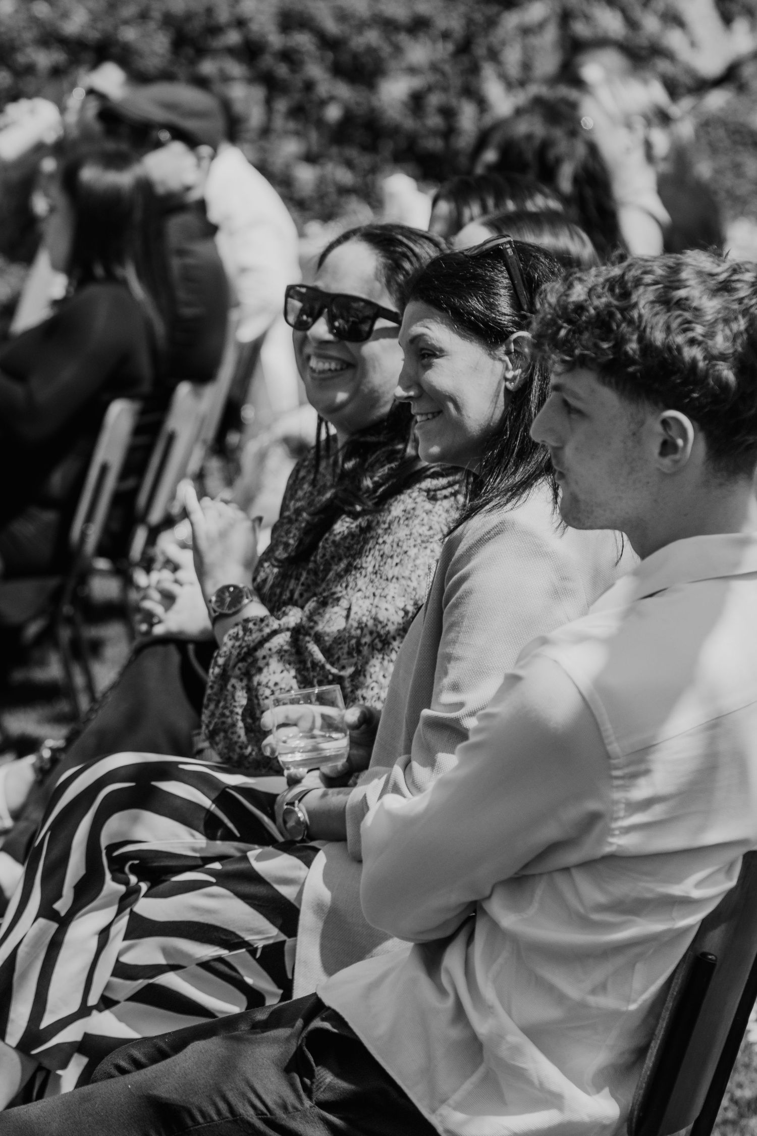 Black and white photo series showing audience members laughing and reacting emotionally during an event.